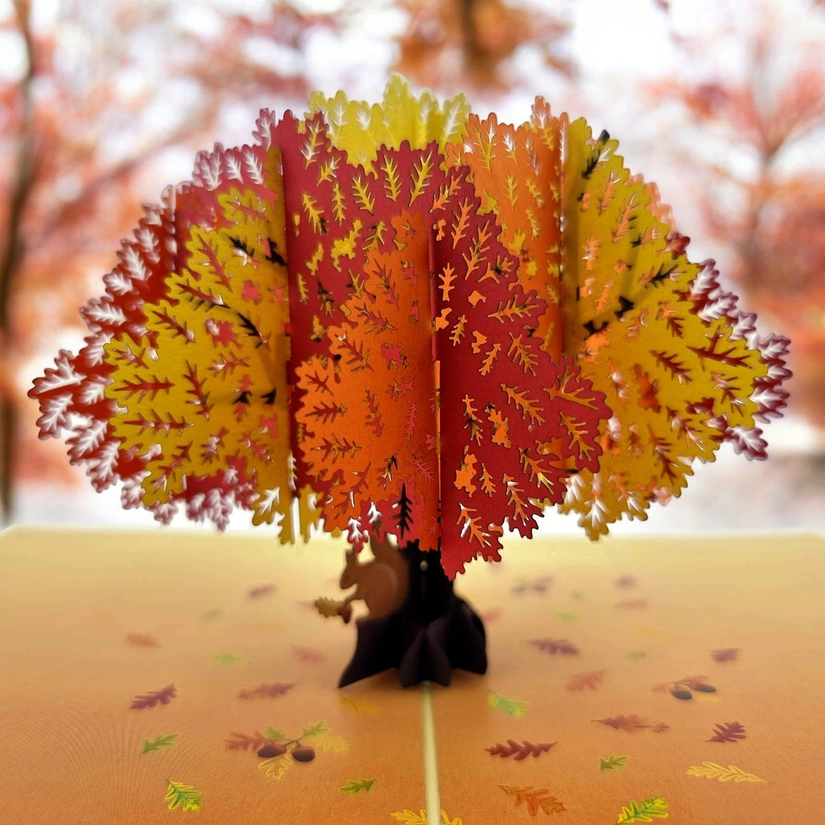 Color Pop Cards Autumn Oak Tree pop-up card with red, orange, and yellow leaves and a squirrel at the base.