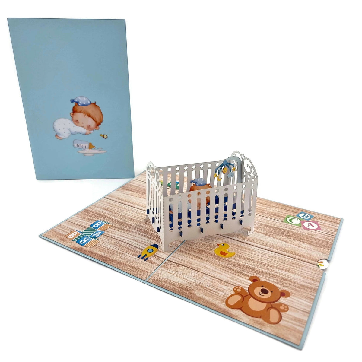 Color Pop Cards blue baby boy crib pop-up greeting card with 3D cot and baby illustration.