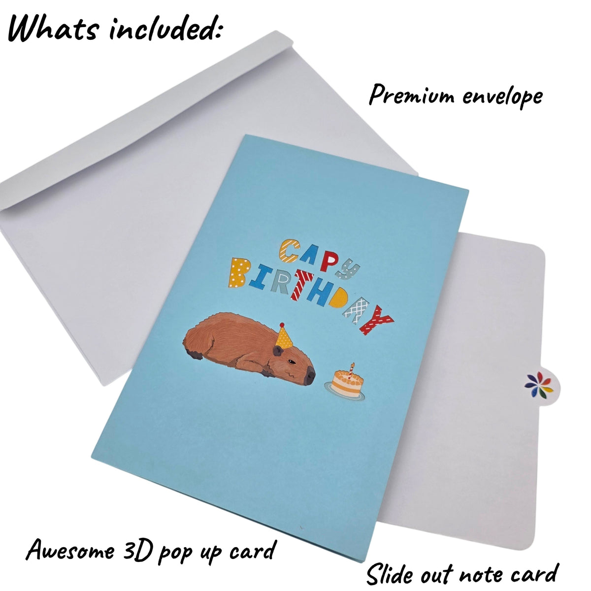 Color Pop Cards light blue birthday card with a 3D capybara wearing a party hat and a cake. Features colorful "CAPY BIRTHDAY" text.