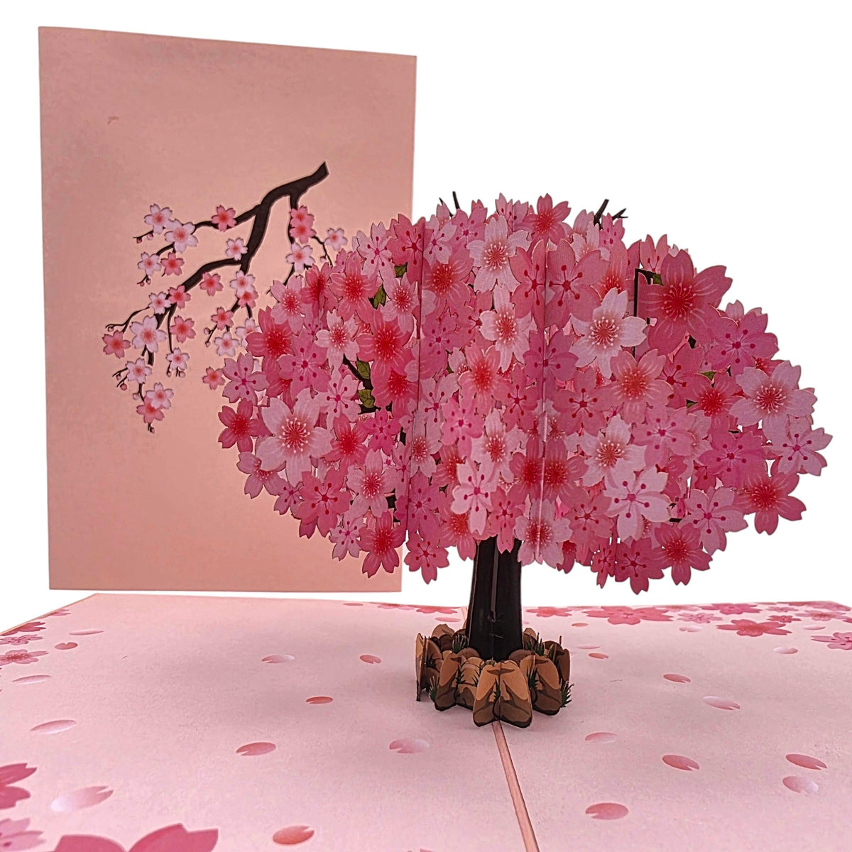Color Pop Cards cherry blossom pop up greeting card with a pink paper tree in full bloom on a matching floral base.