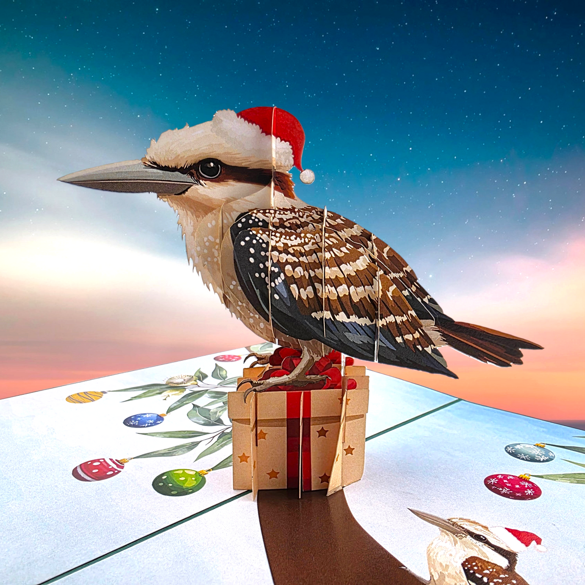 Color Pop Cards Christmas Kookaburra pop-up card featuring a bird in a Santa hat sitting on a gift box
