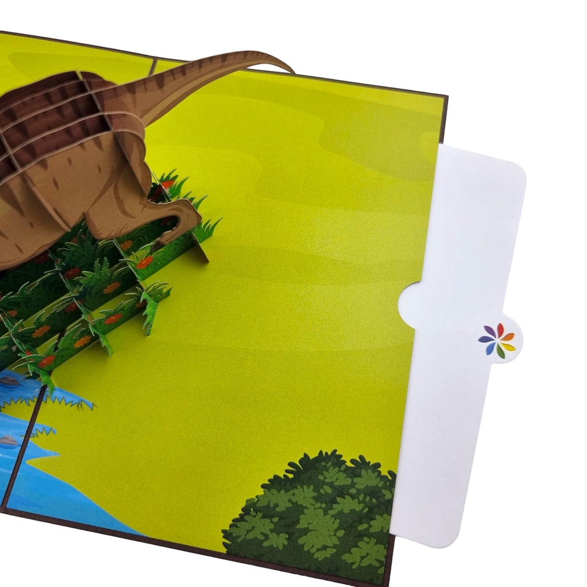 Color Pop Cards Dinosaur Pop Up Card featuring a 3D T-Rex, greenery, and river scene. Cardstock material.