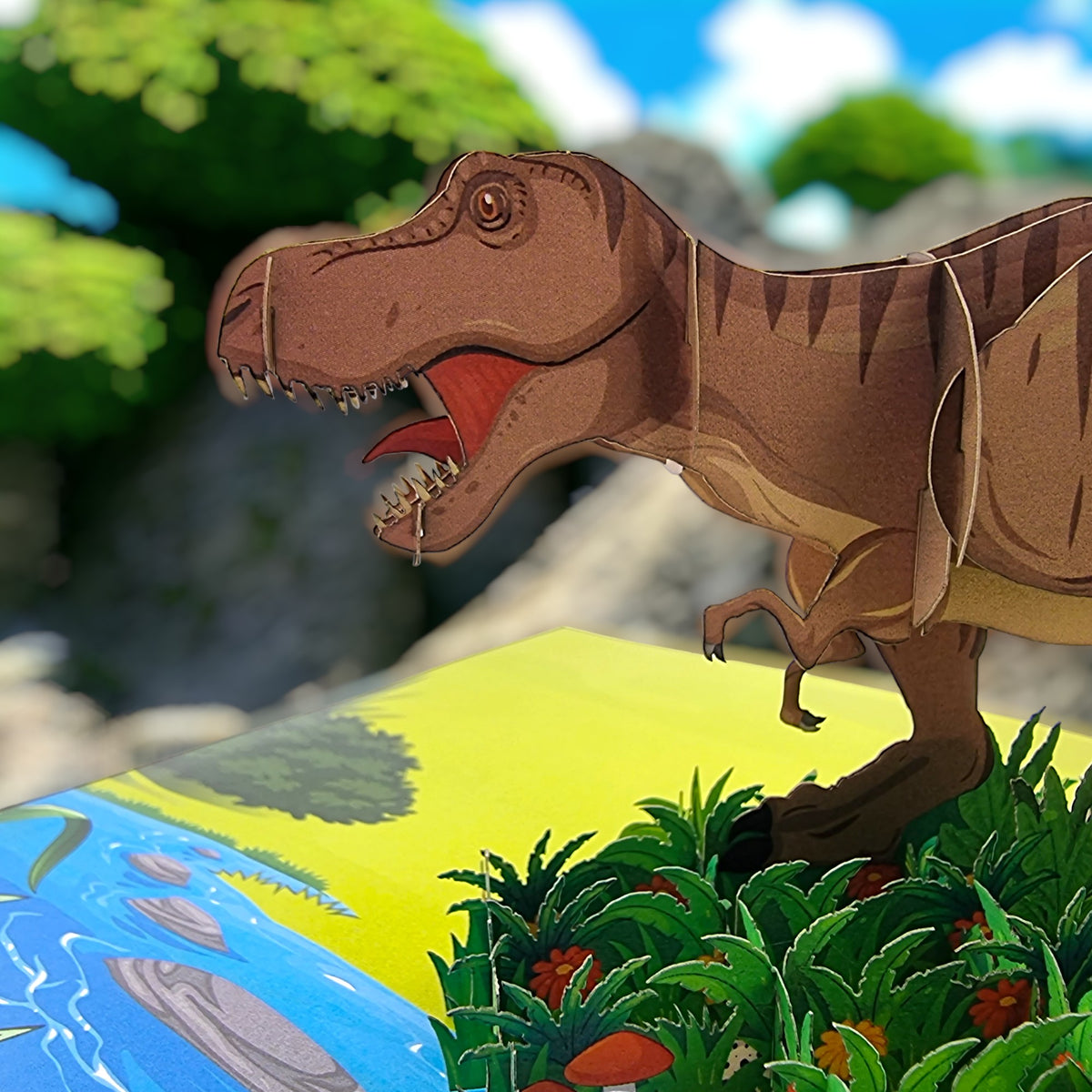 Color Pop Cards T-Rex dinosaur pop-up card with river and greenery. Cardstock construction.