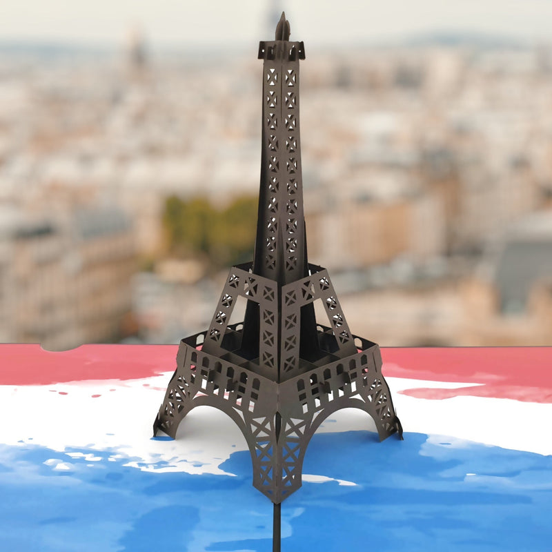 Color Pop Cards Eiffel Tower pop-up card with intricate laser-cut details and a French flag background.