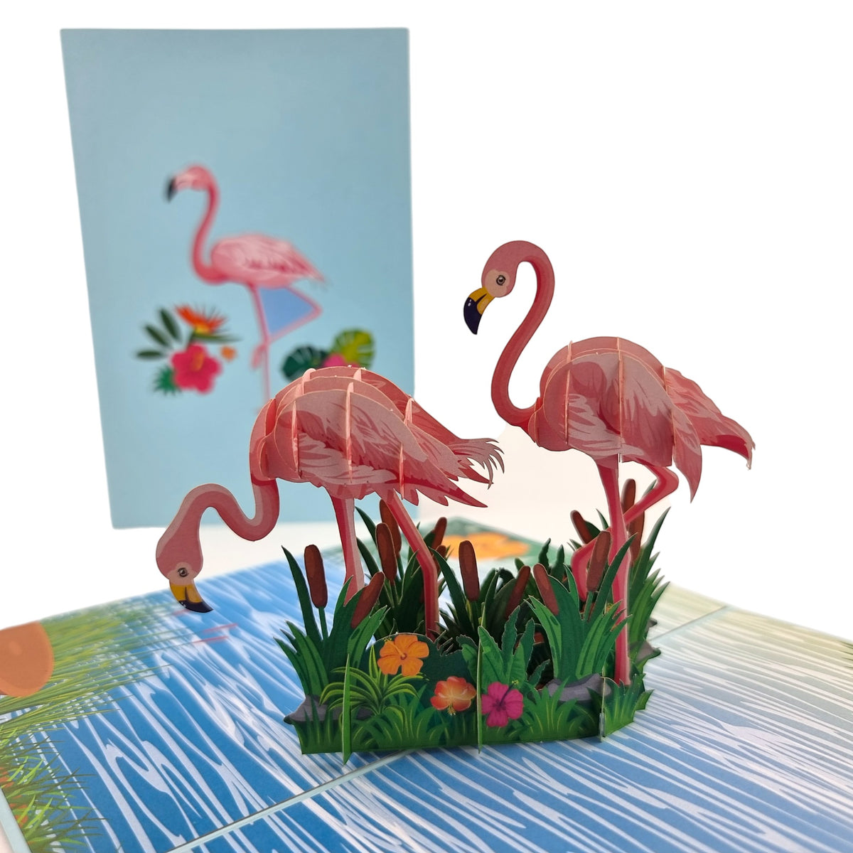 Color Pop Cards Flamingo Tropical Paradise pop-up card with two pink flamingos in reeds and flowers on a blue water background.