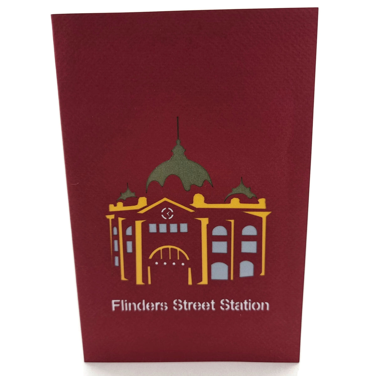 Color Pop Cards maroon pop-up card featuring a yellow and grey silhouette of Flinders Street Station with a green dome.