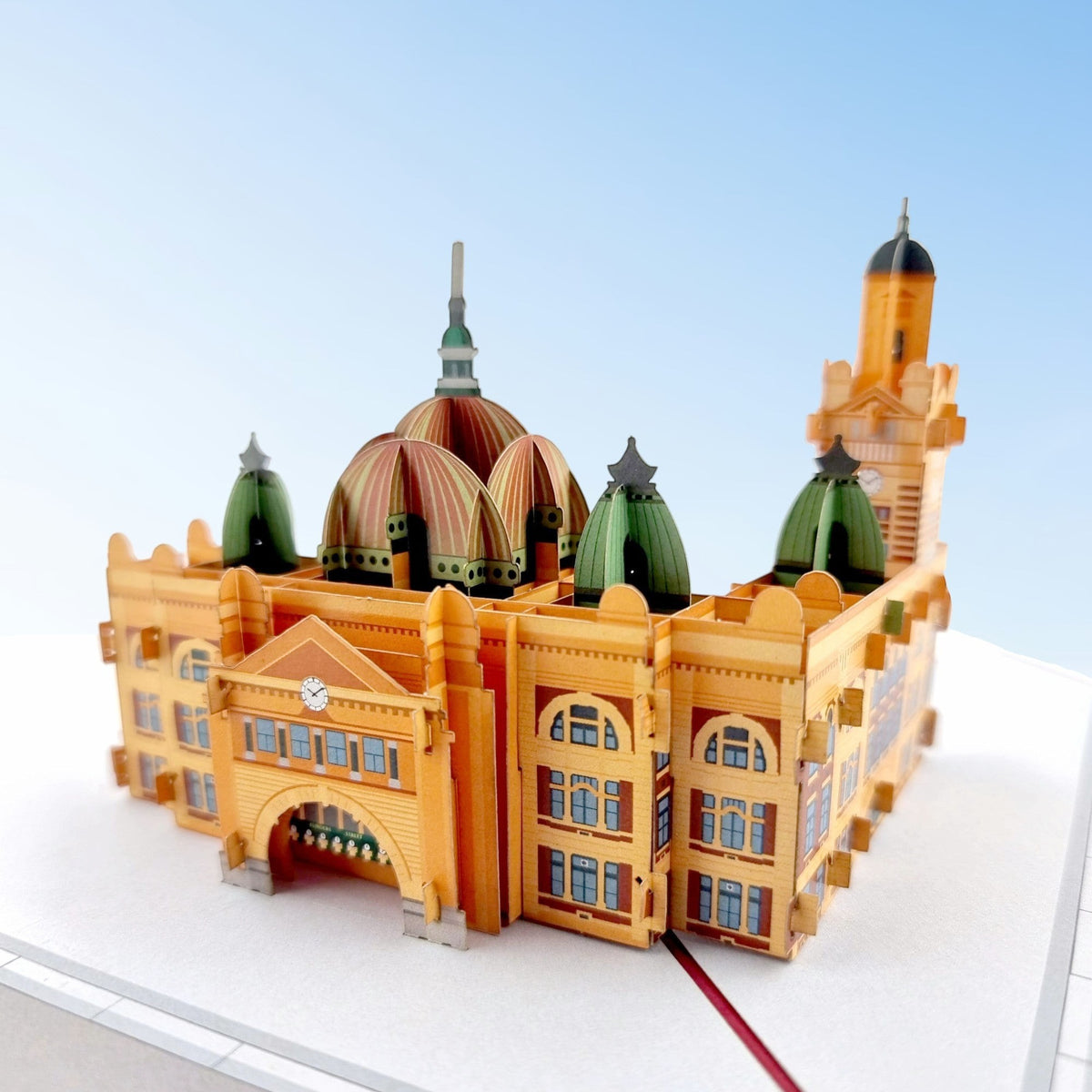 Color Pop Cards Flinders Street Station pop-up card, a 3D paper model of the iconic Melbourne landmark with orange facade and green domes.