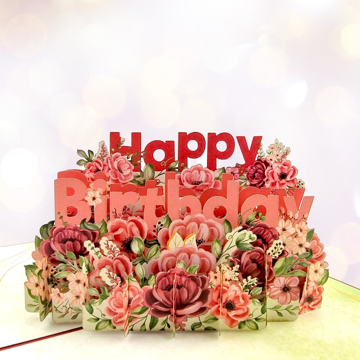 Color Pop Cards floral birthday pop up card with 3D red "Happy Birthday" text and vibrant paper flowers.