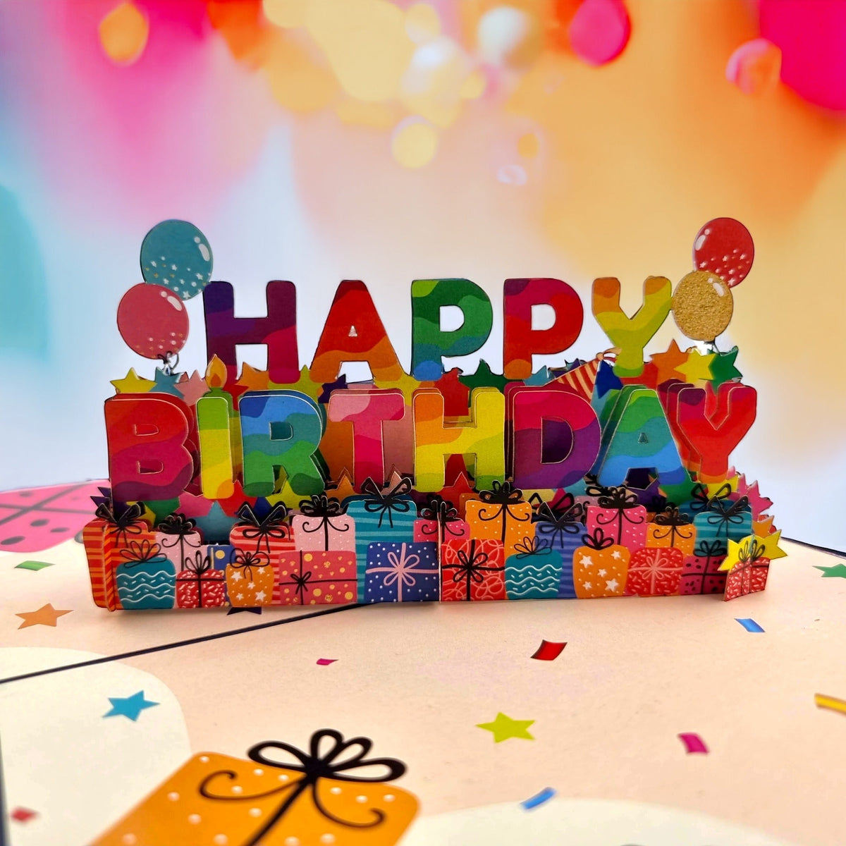 Color Pop Cards Happy Birthday pop-up card with rainbow lettering, gifts, and balloons. 12x18cm.