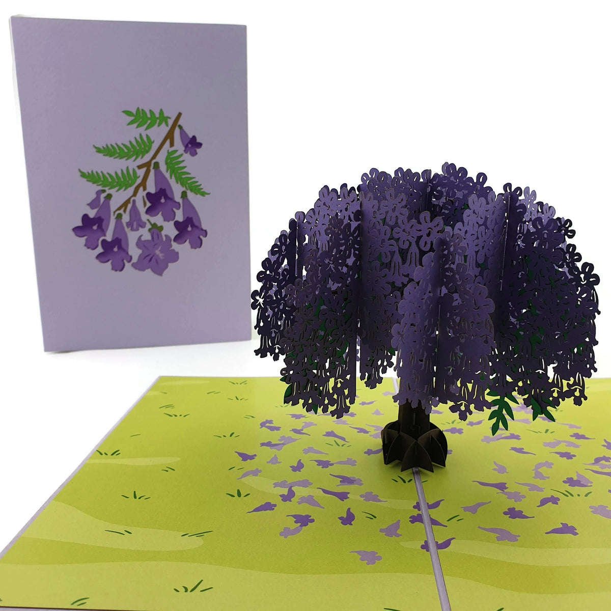 Color Pop Cards Jacaranda Tree pop-up card with purple flowers and green field. Blank interior.