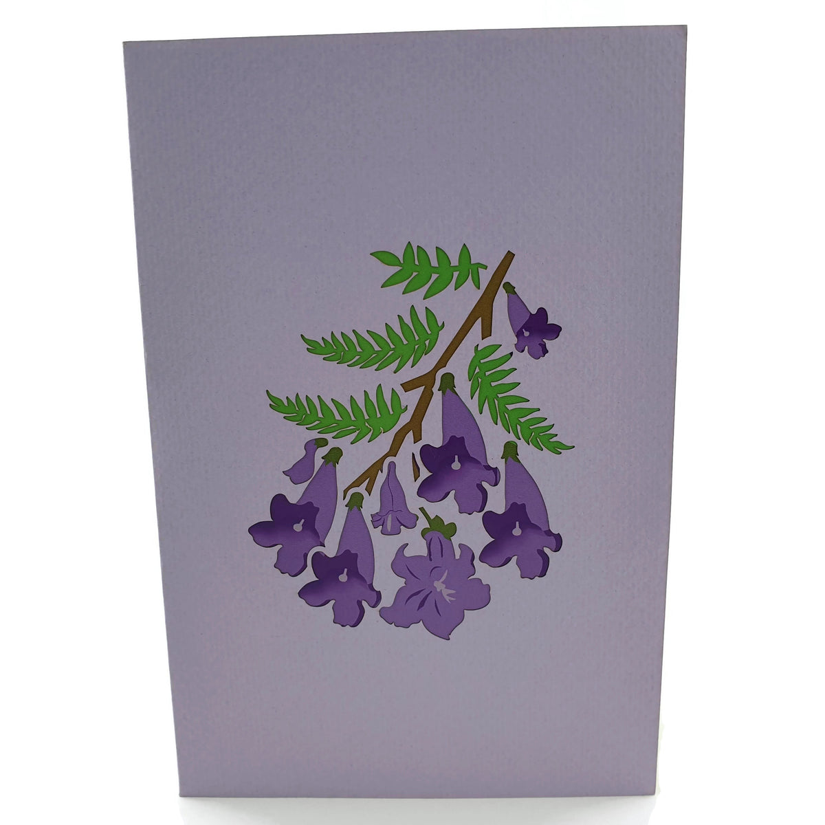 Color Pop Cards Jacaranda Tree pop-up card with purple flowers and green leaves on a light purple background.