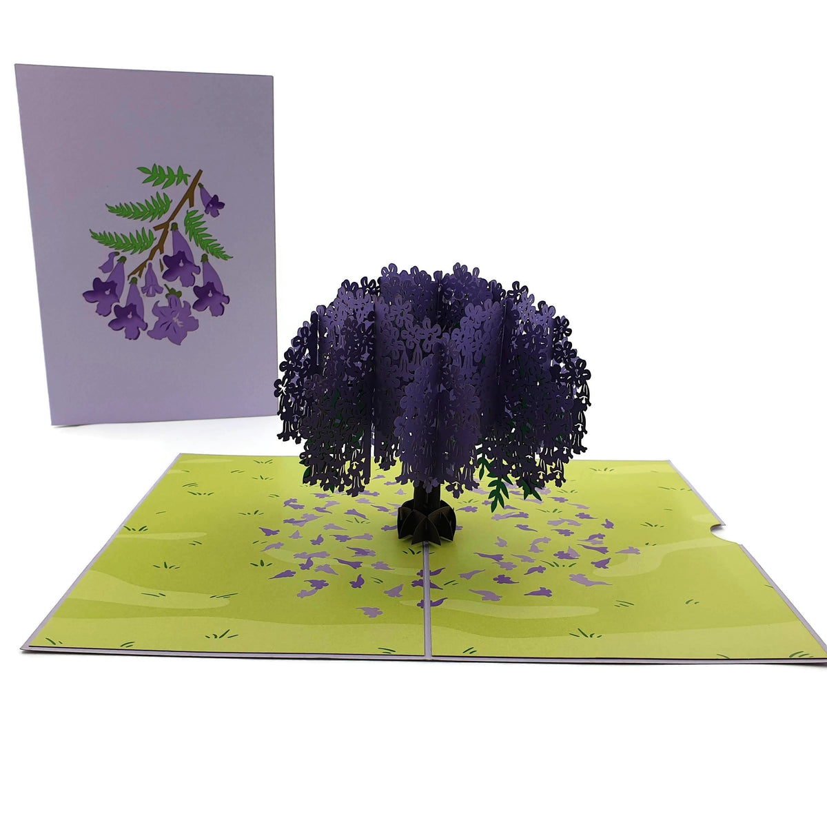 Color Pop Cards Jacaranda Tree pop-up card with purple flowers and green field. Blank interior.