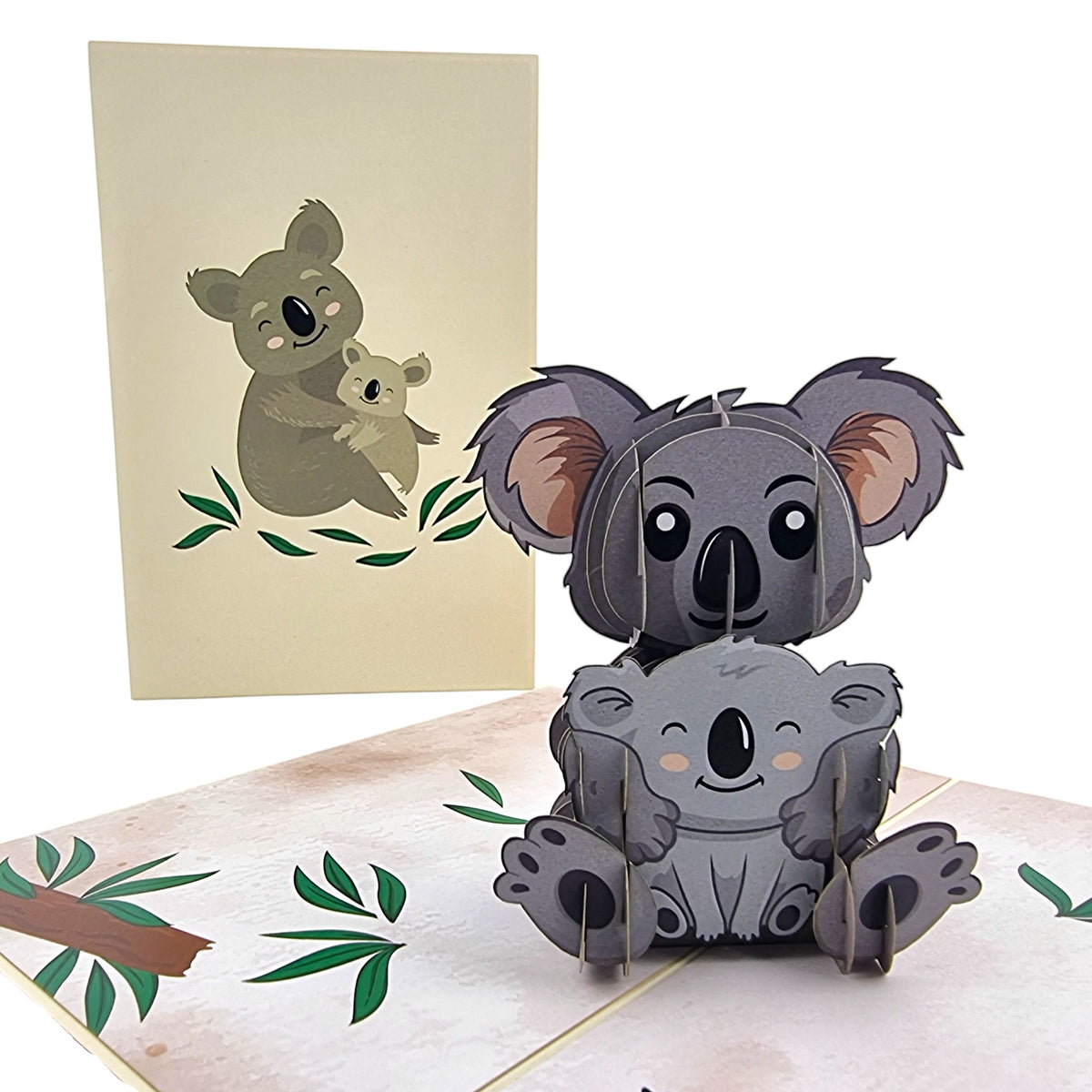 Color Pop Cards Koala Family pop-up card featuring a mother koala holding a baby koala. Card is grey and beige.