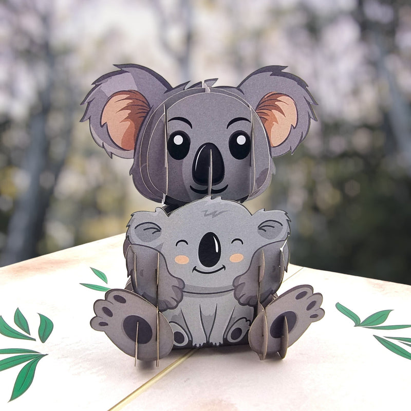 Color Pop Cards Koala Family pop-up card featuring two grey koalas, one larger than the other, with green leaf accents.