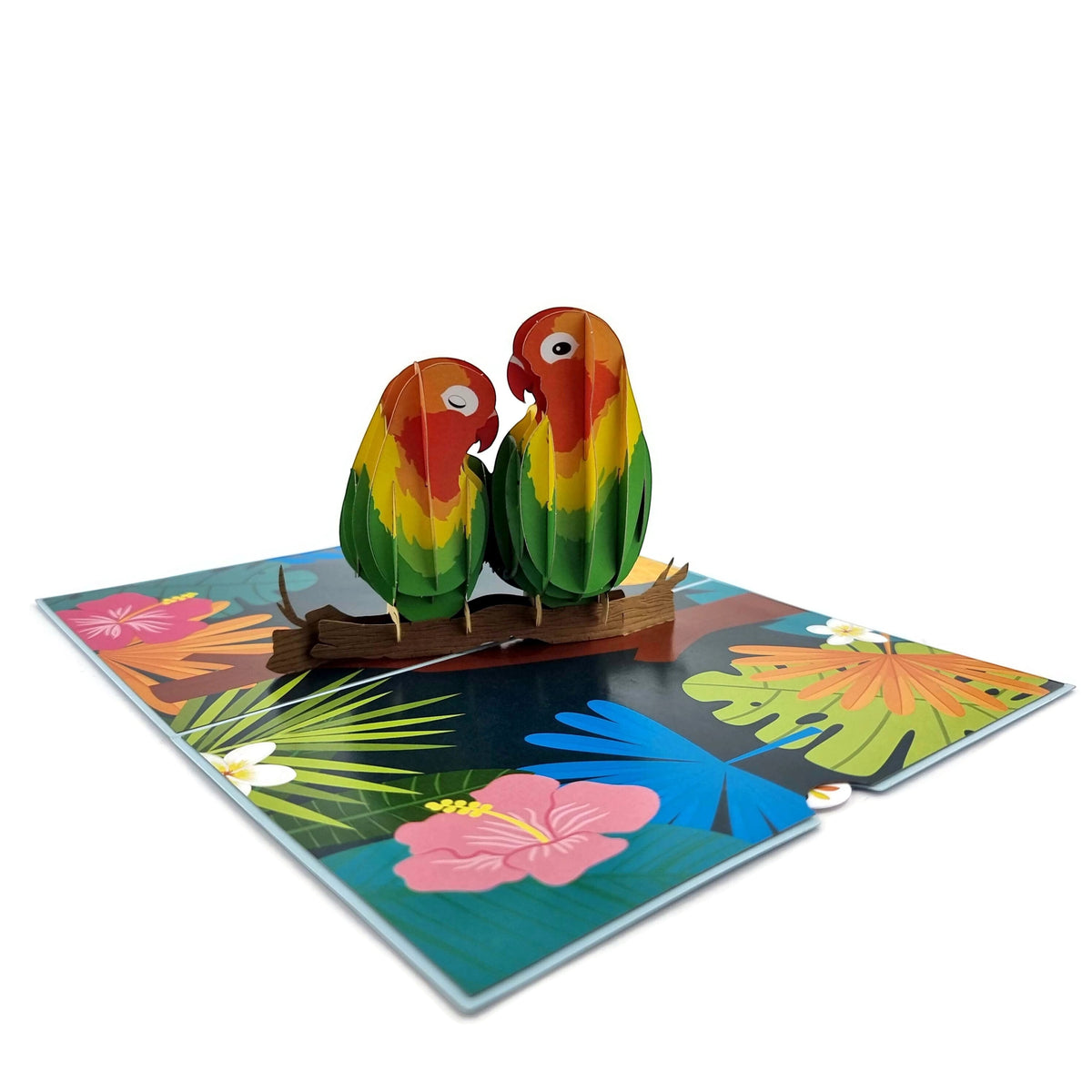 Color Pop Cards Love Birds pop-up card with two colorful parrots on a branch amidst tropical flowers.