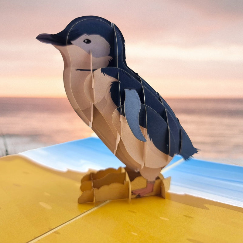 Color Pop Cards Little Penguin pop-up card featuring a 3D penguin on a beach scene. Perfect for birthdays or bird lovers.