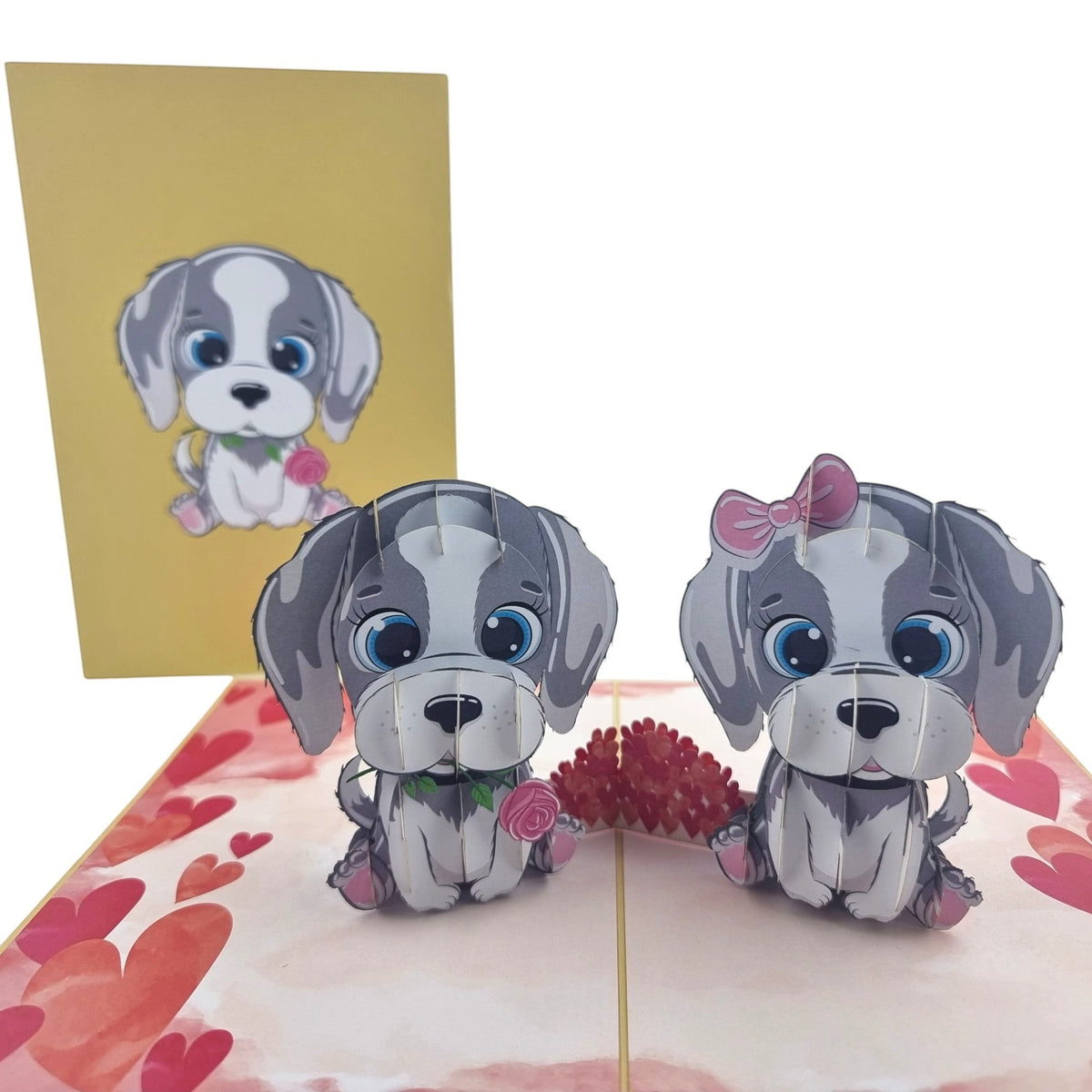 Color Pop Cards Puppy Love pop-up card featuring two grey and white cartoon puppies, one with a pink bow, holding roses. Includes envelope.
