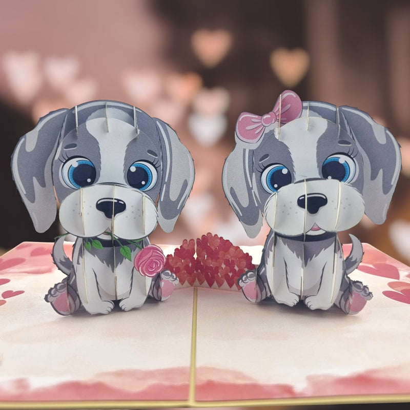 Color Pop Cards Puppy Love Pop Up Card featuring two grey and white cartoon puppies, one holding a pink rose, the other with a pink bow.