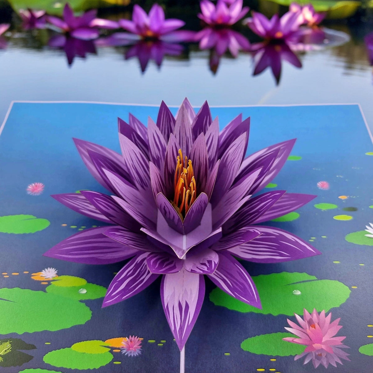Color Pop Cards purple water lily pop up card with green lily pads and blue water background.