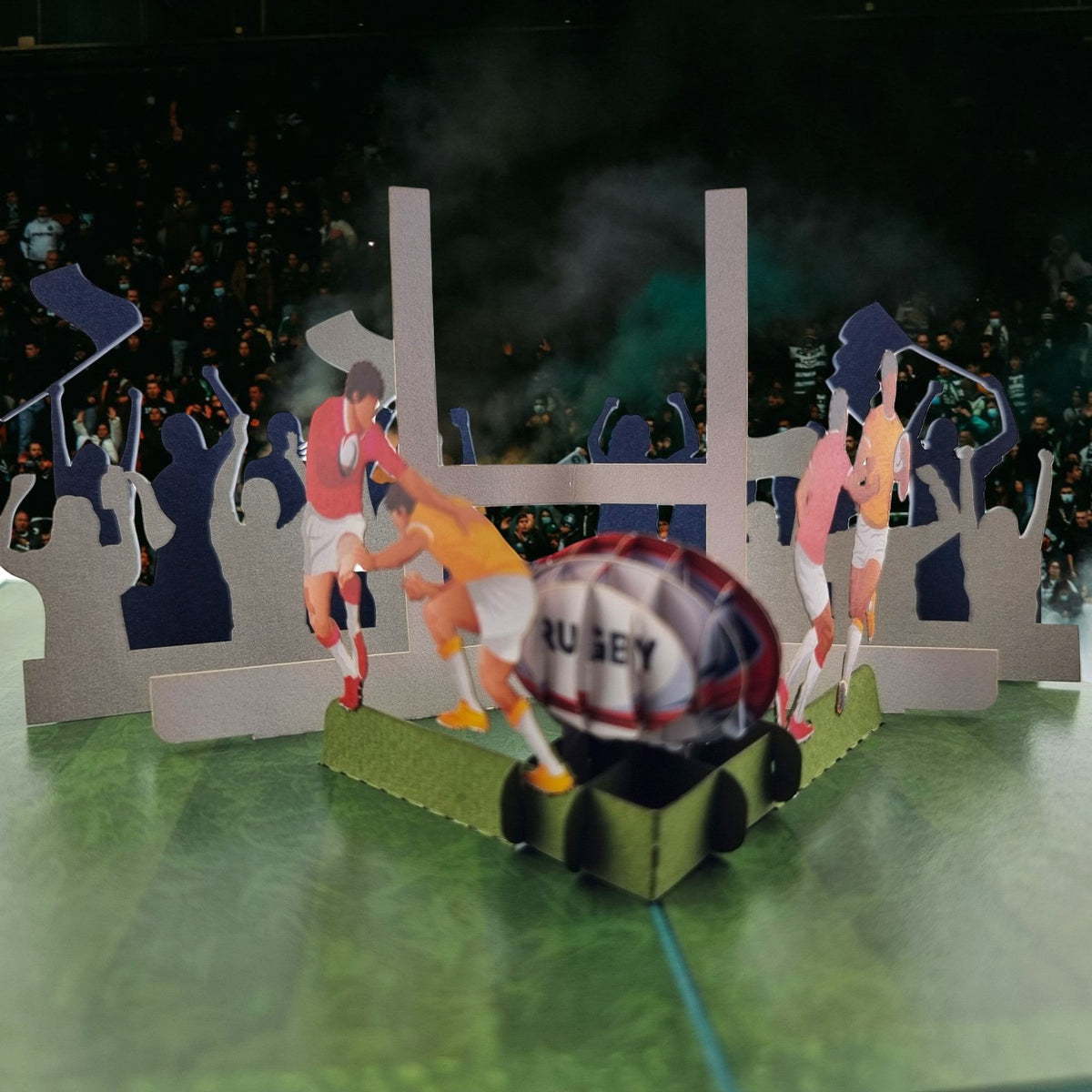 Color Pop Cards Rugby pop up card featuring players, goalposts, and a rugby ball on a green field with a cheering crowd.