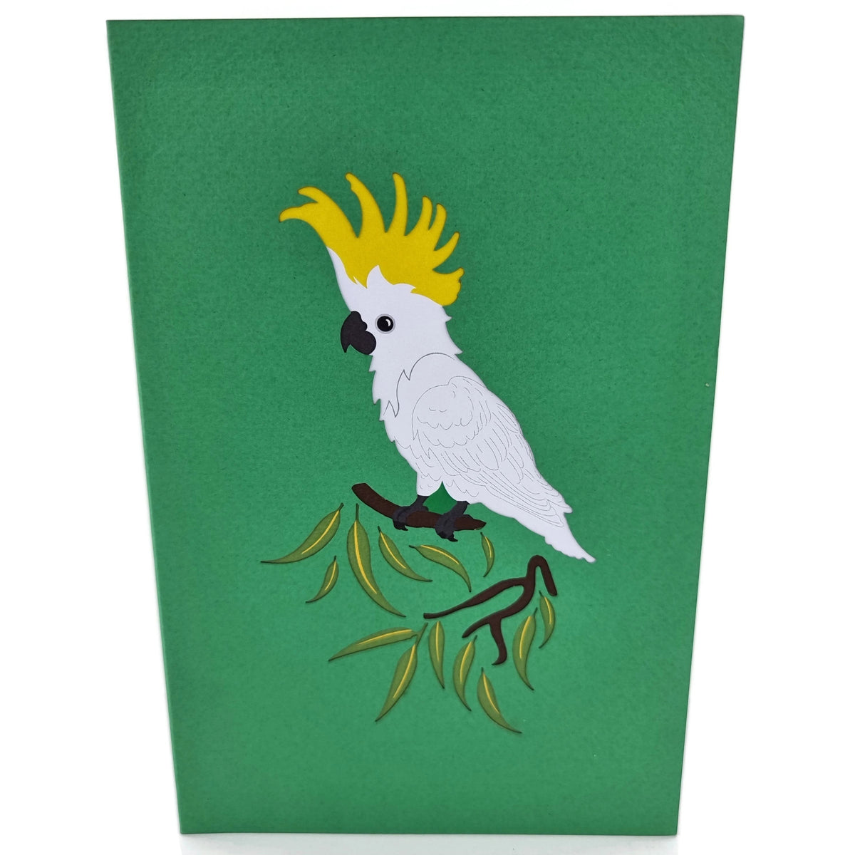 Color Pop Cards green pop-up card featuring a white Sulphur Crested Cockatoo with a yellow crest perched on a branch with green leaves.