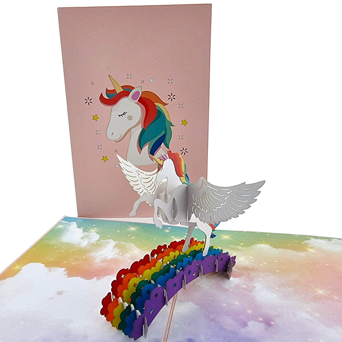 Color Pop Cards pink pop-up card featuring a winged unicorn on a rainbow. Features 3D papercraft.
