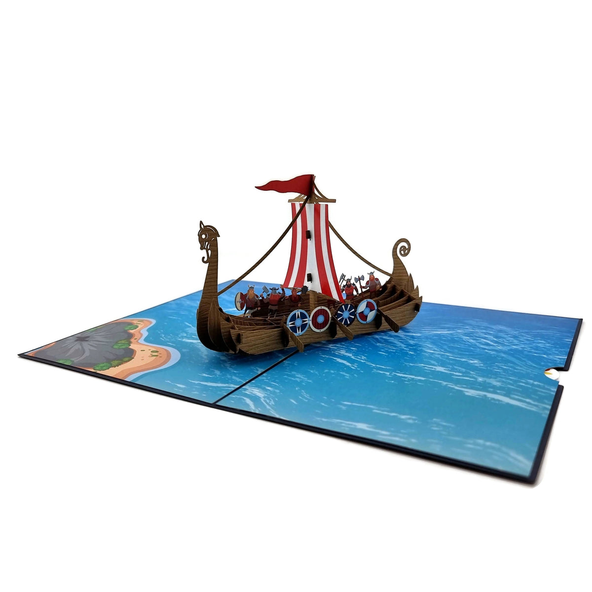Color Pop Cards Viking ship pop-up card with intricate details, shields, oars, and dragon bow. Features a red and white striped sail.