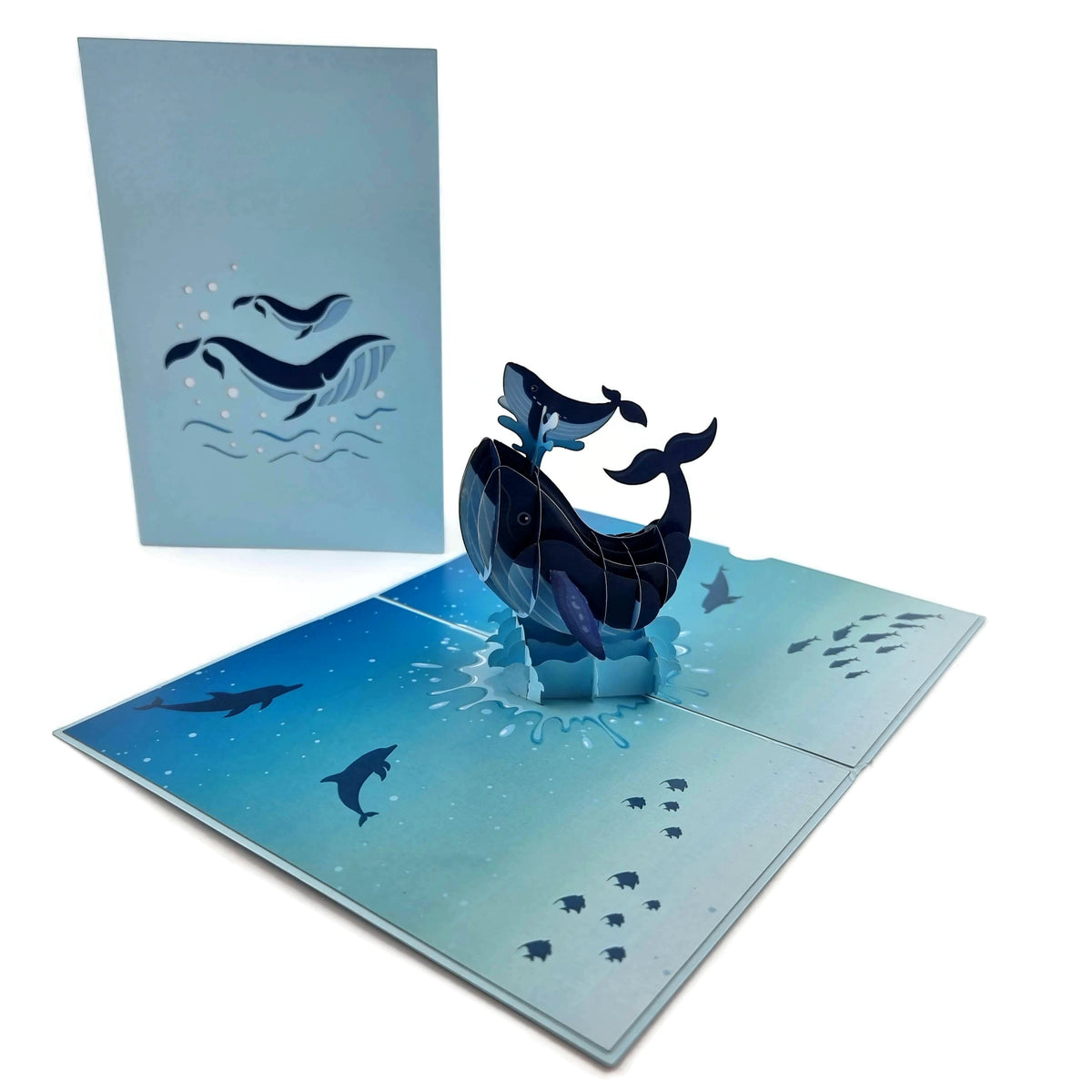 Color Pop Cards blue whale family pop up card with mother and baby whale jumping out of water.